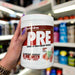 Close-up of (Per4m Pre Workout Stim 570g 30 Servings) held up inside My Supplement Shop, clearly showing the front label in a Sports Nutrition setting.